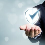 Businessman holding shield protect icon