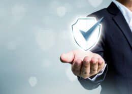 Businessman holding shield protect icon