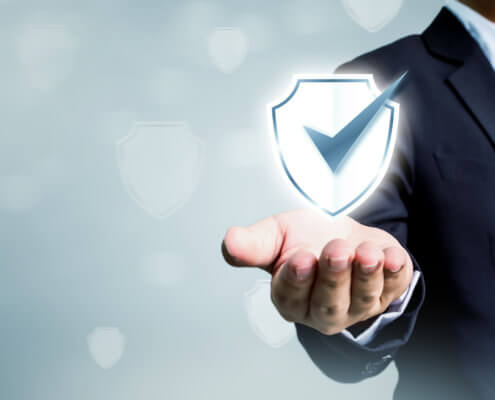 Businessman holding shield protect icon