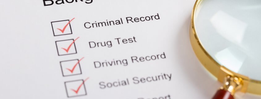 magnifying glass over background check form