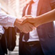 businessman shaking hands with background screening provider