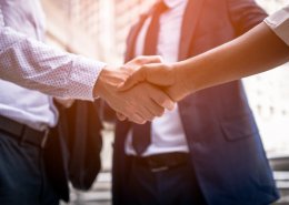 businessman shaking hands with background screening provider