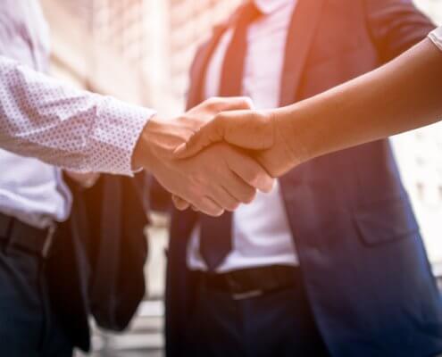 businessman shaking hands with background screening provider