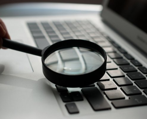 running a personal background check on laptop