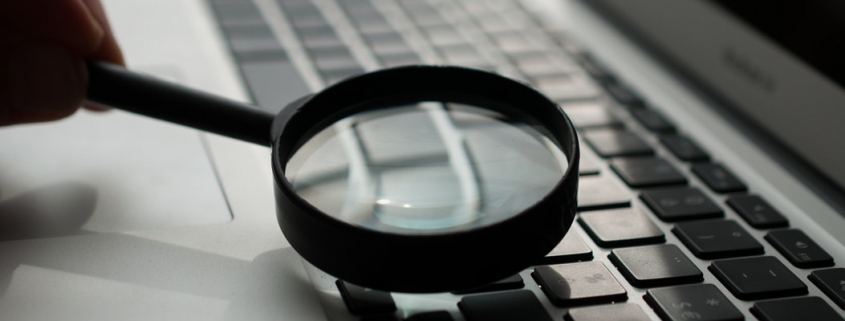 running a personal background check on laptop