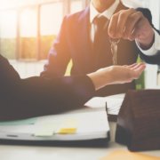 renter handing keys to future tenant of home
