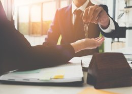 renter handing keys to future tenant of home
