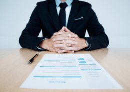 HR and resume of applicant undergoing background check and interview on table.