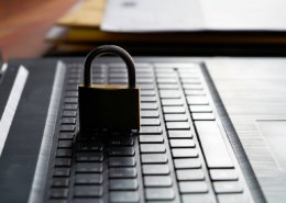 Computer keyboard and padlock as a symbol of network admin preforming principle of least privilege