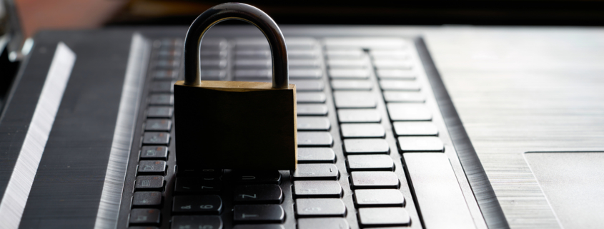 Computer keyboard and padlock as a symbol of network admin preforming principle of least privilege