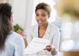 Young woman interviewing with company who has to make hiring decisions