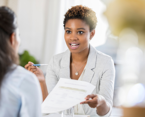 Young woman interviewing with company who has to make hiring decisions