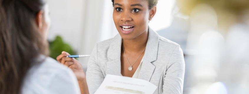 Young woman interviewing with company who has to make hiring decisions