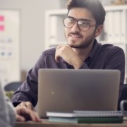 Young man interviewing at an office after NAPBS background compliance was met