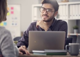 Young man interviewing at an office after NAPBS background compliance was met