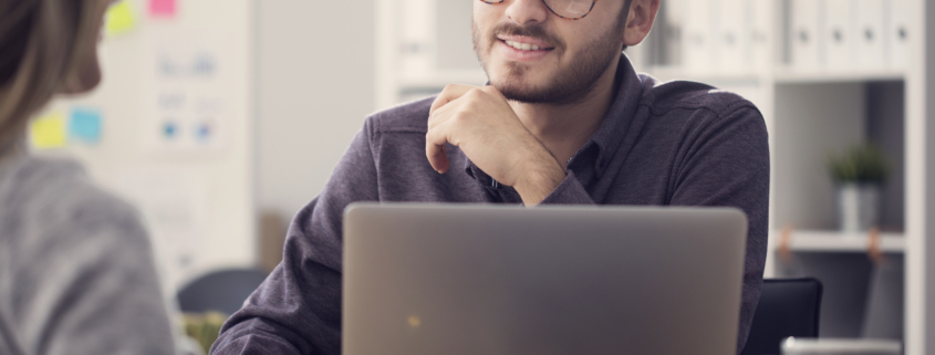 Young man interviewing at an office after NAPBS background compliance was met