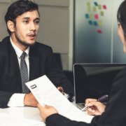 Human resource manager interviewing the male employment candidate in the office room after background checks