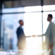 men shaking hands after background check verified past employee experiences