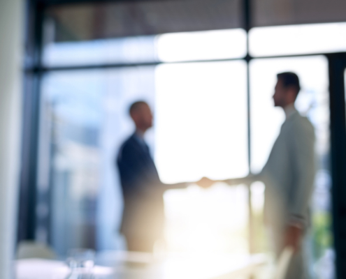 men shaking hands after background check verified past employee experiences