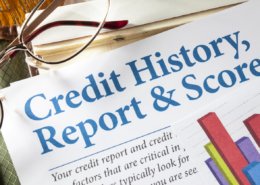 Credit Reports and Score with chart and glasses on desk
