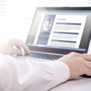 A close-up shot of someone using a laptop to review a resume with the best user experience.