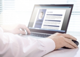 A close-up shot of someone using a laptop to review a resume with the best user experience.