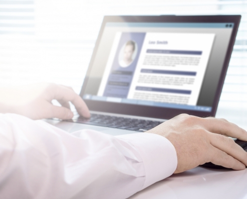 A close-up shot of someone using a laptop to review a resume with the best user experience.