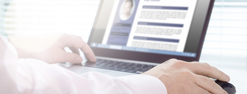 A close-up shot of someone using a laptop to review a resume with the best user experience.