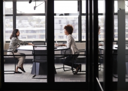 A manager interviewing a job candidate after performing a background check with a firm with PABS accreditation.