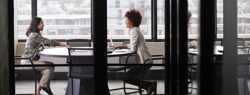 A manager interviewing a job candidate after performing a background check with a firm with PABS accreditation.