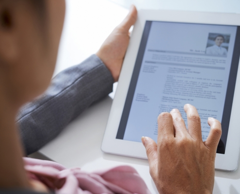 An HR representative using a tablet for an integrated background check.