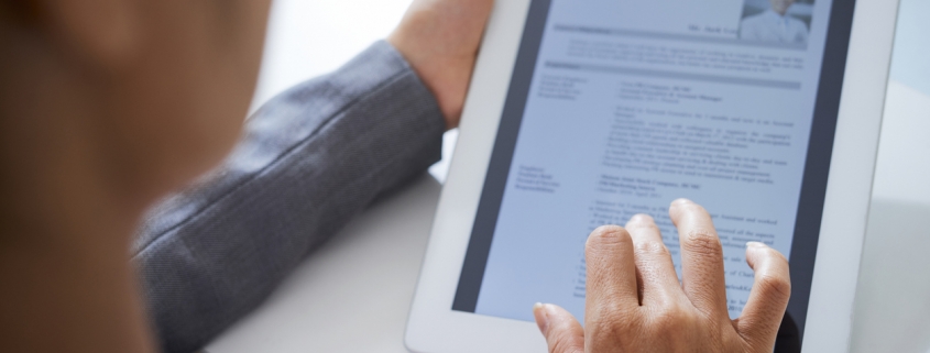 An HR representative using a tablet for an integrated background check.